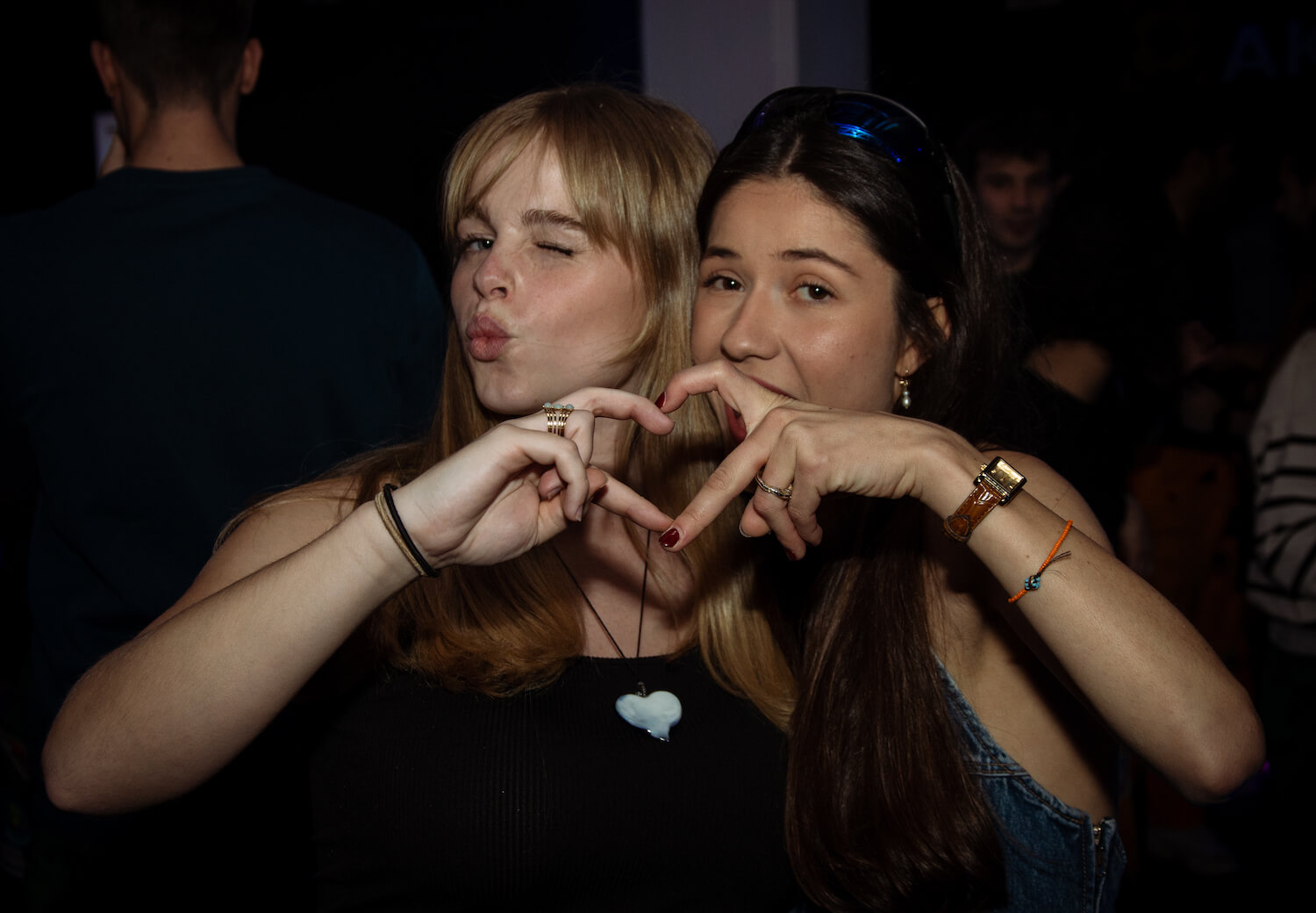 Girls do a heart with their fingers in Akademien Nightclub.